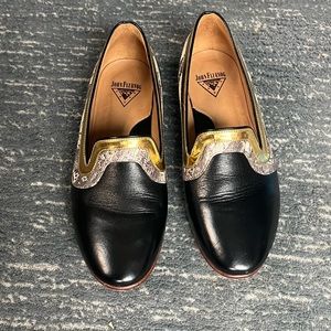 John Fluevog black shoes with leopard and gold trim.
